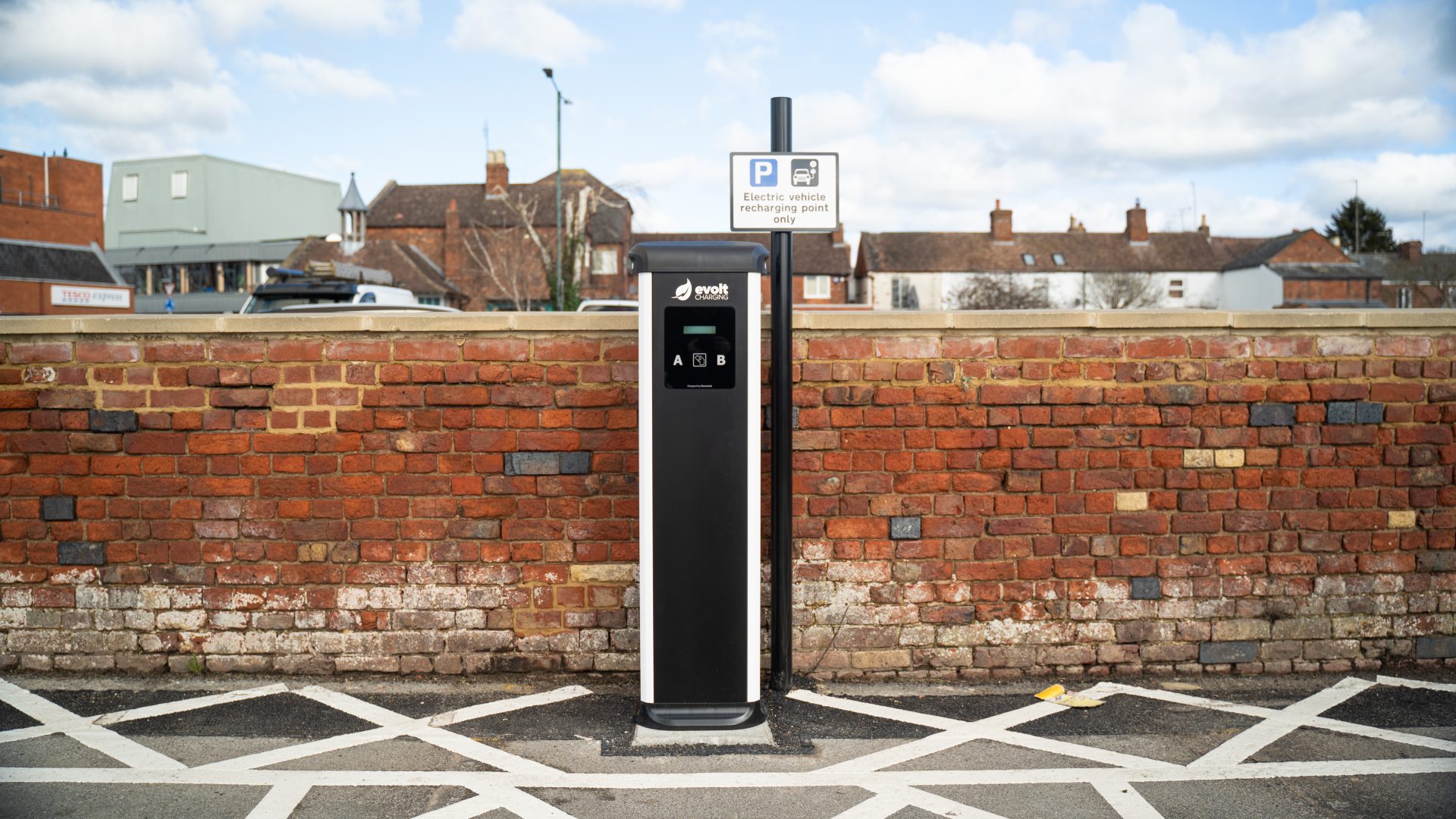 Dual-socket EV charger installed beside marked parking bays