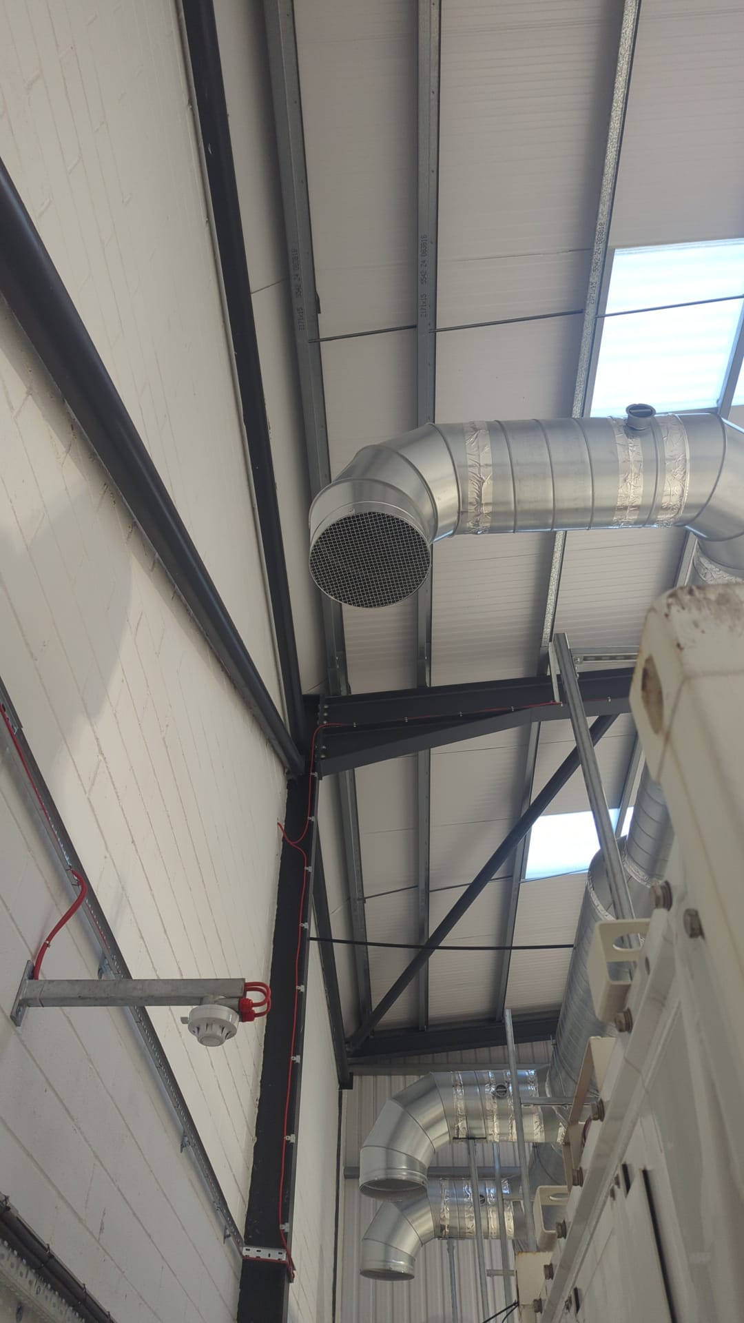 Three-phase power distribution and fire alarm detector installed alongside refrigeration equipment